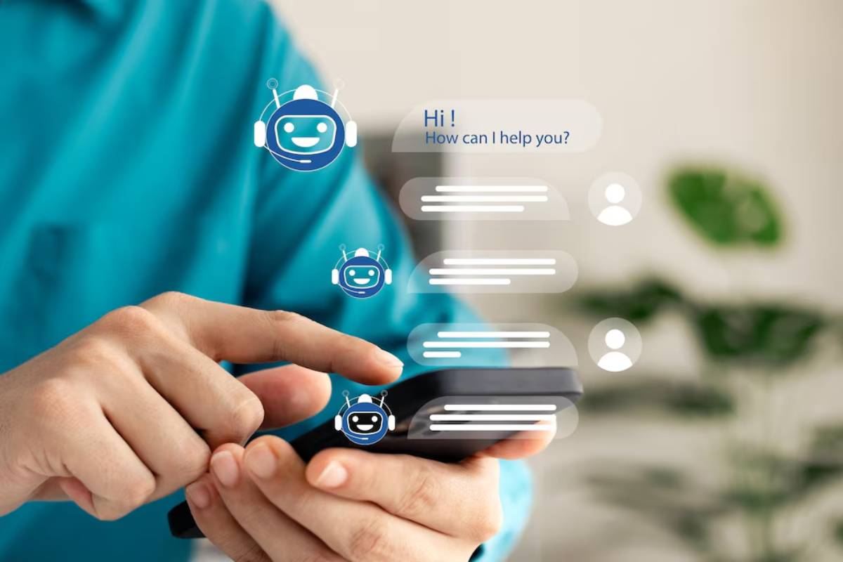 Person using smartphone interacting with chatbot icons and conversation bubbles, suggesting digital communication technology.