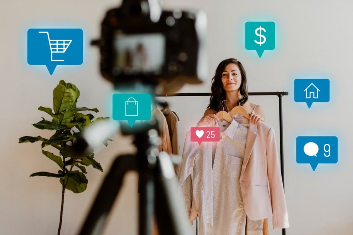 Woman recording a fashion vlog, showcasing clothes with floating social media interaction icons around her.