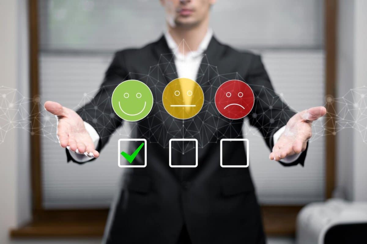 Businessman presenting virtual rating system with smiley, neutral, and sad face icons; green smiley is selected with a checkmark.