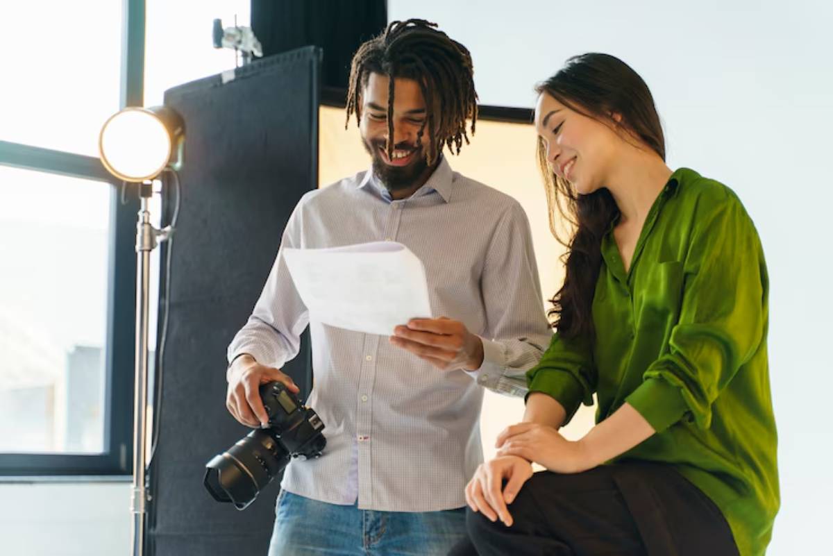 Two person collab, preparing for video shoot in a modern well-lit studio.